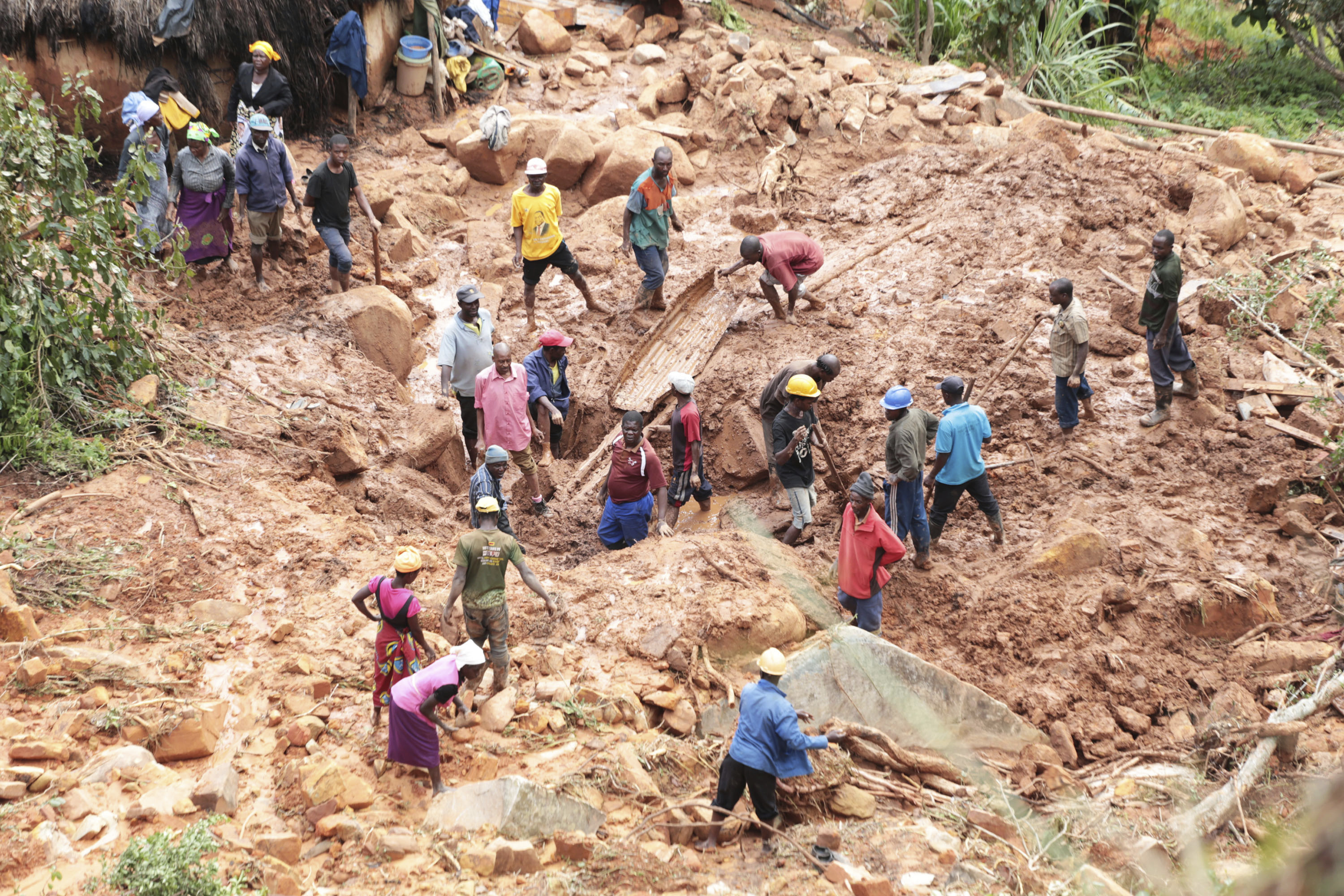 A family dig for their son who got buried in the mud when Cyclone Idai struck in Chimanimani about 600 kilometres south east of Harare, Zimbabwe, Tuesday, March, 19, 2019.