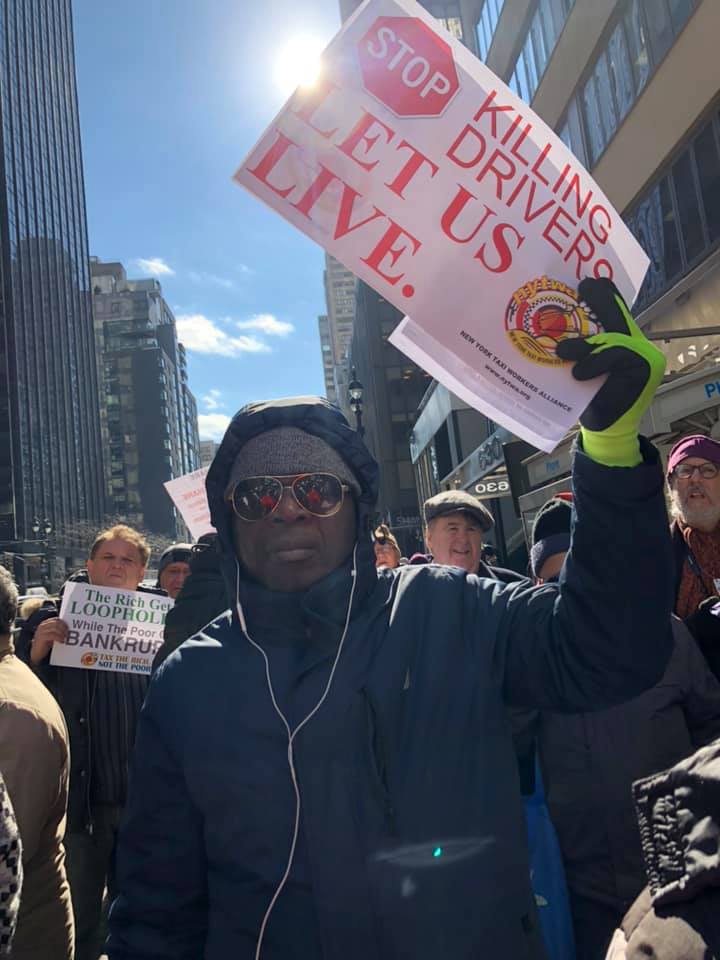 Taxi driver holding up a sign that says