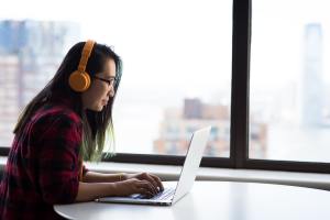 A woman typing at a computer.