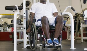 Man in wheelchair working out in gym