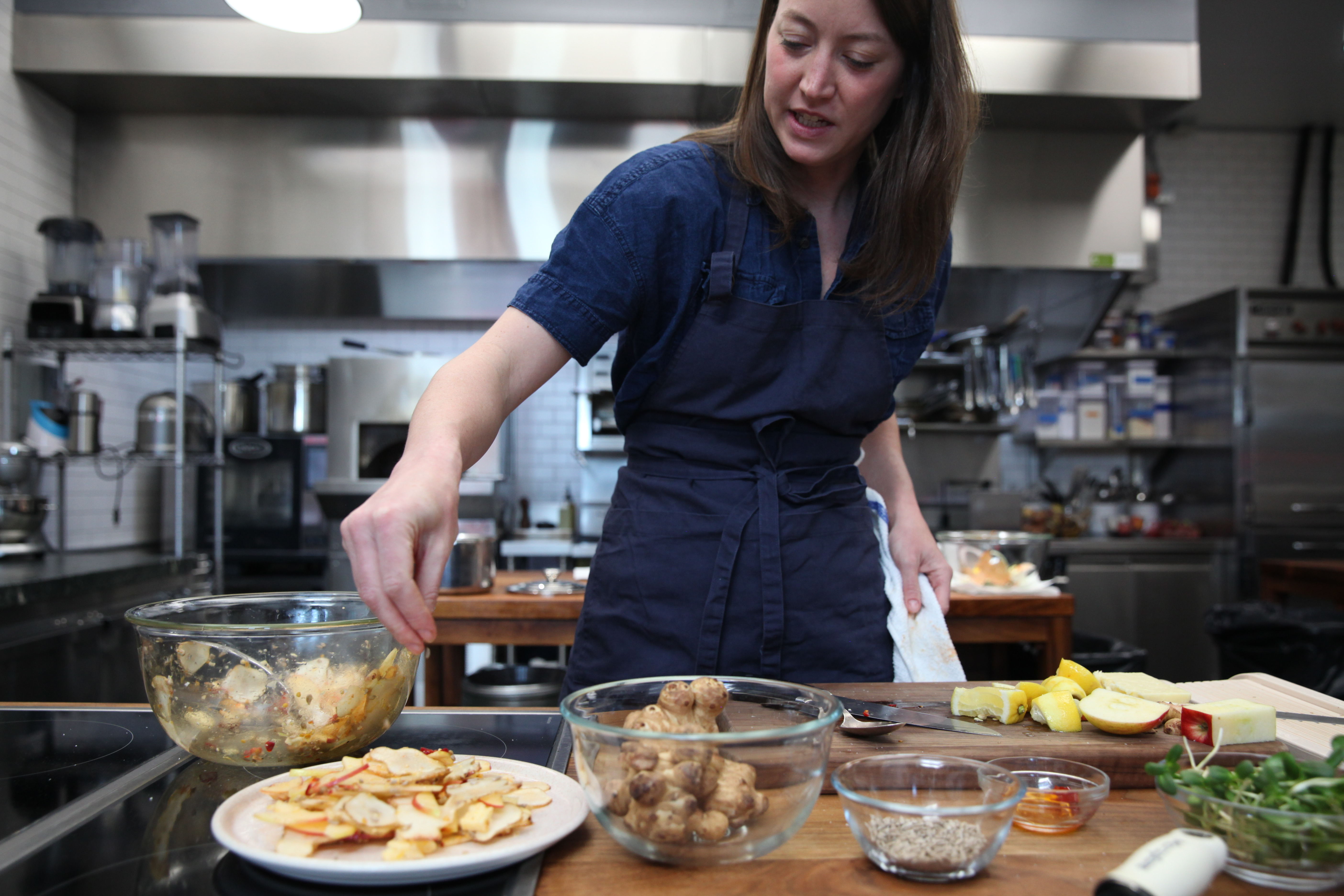 chef julia sullivan of henrietta red preparing salad