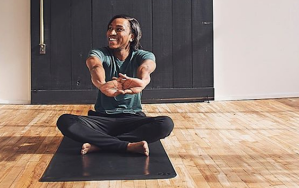 Yoga instructor stretching on mat