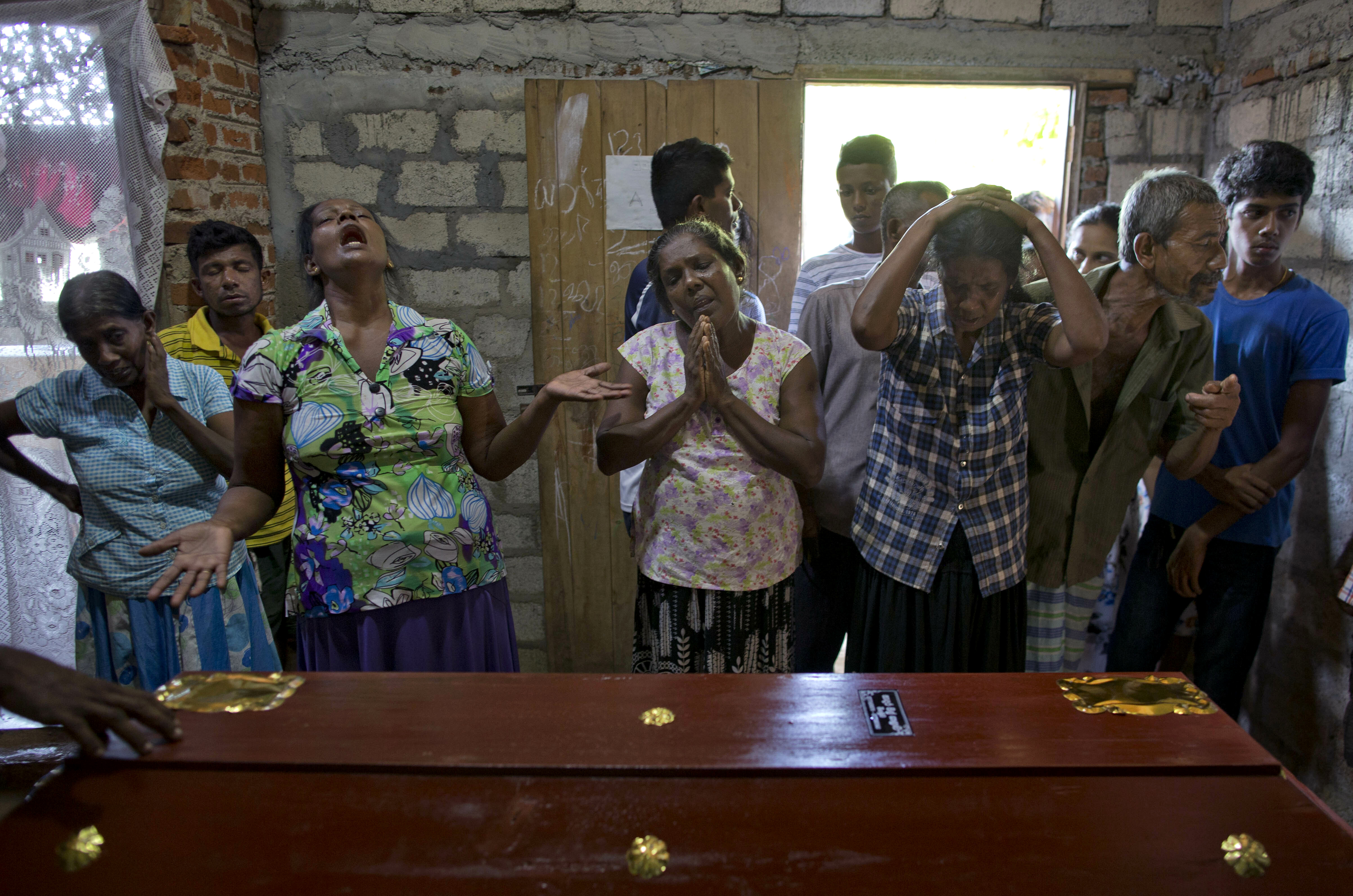 Relatives weep near the coffin with the remains of 12-year Sneha Savindi, who was a victim of Easter Sunday bombing at St. Sebastian Church, Monday, April 22, 2019 in Negombo, Sri Lanka. Easter Sunday bombings of churches, luxury hotels and other sites was Sri Lanka's deadliest violence since a devastating civil war in the South Asian island nation ended a decade ago. (AP Photo/Gemunu Amarasinghe)