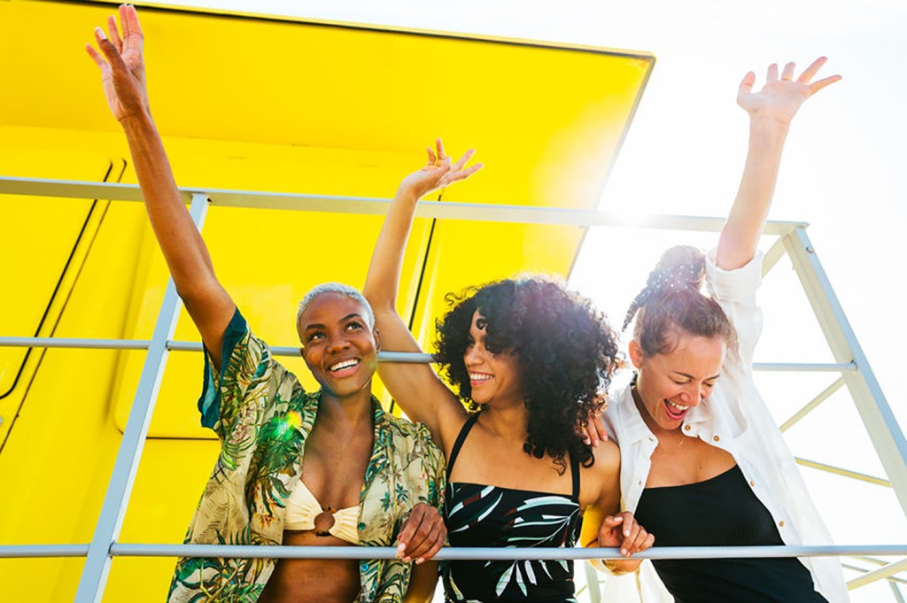 Happy women waving their hands in the air