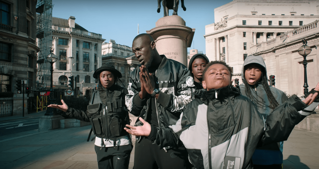 Stormzy surrounded by children in the video for 'Vossi Bop'