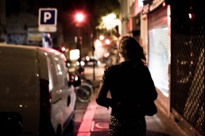 A woman walking at night.