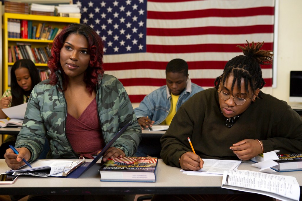 A transfeminine student sitting next to a non-binary student in class copy (2)