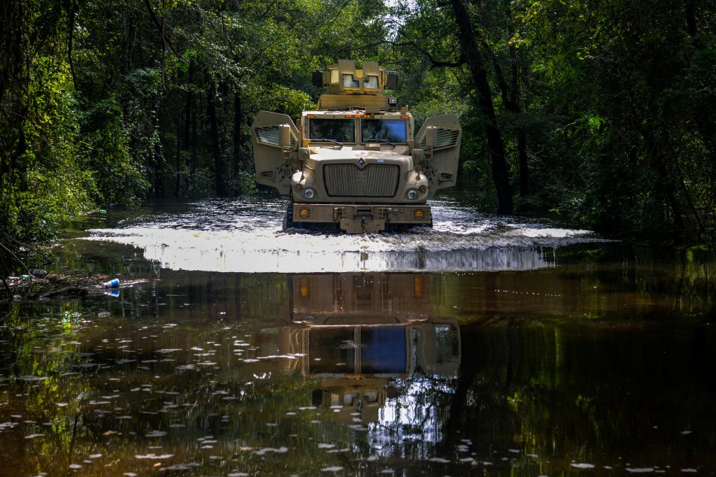 A military truck drives through floodwater from Hurricane Florence in 2018.