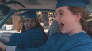 Beanie Feldstein and Kaitlyn Dever in graduation attire