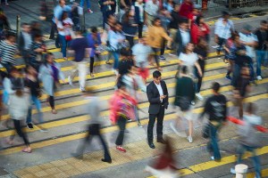 Man in crowd holding a phone