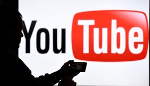 YouTube has caved to enormous pressure to punish a popular right-wing video creator for his racist and homophobic bullying of a journalist  — sort of.