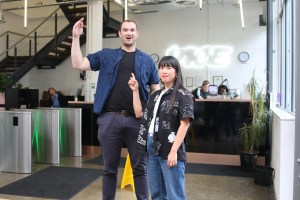 Tall man standing next to smaller woman