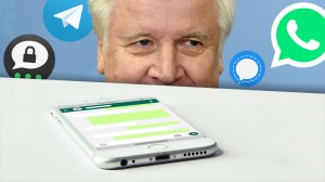 Seehofer schaut auf ein Smartphone