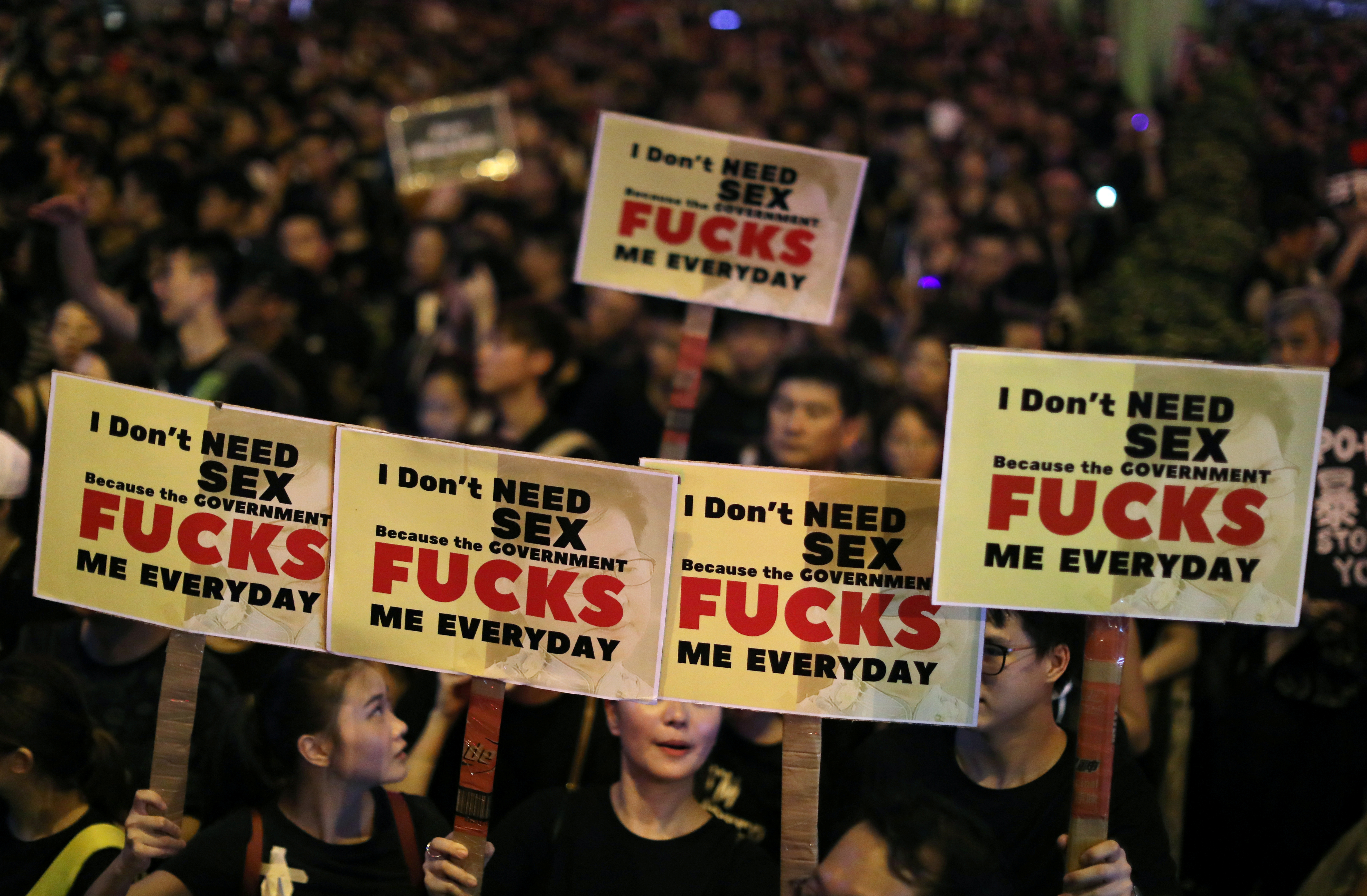 Protesters hold placards as they demand Hong Kong's leaders to step down and withdraw the extradition bill.