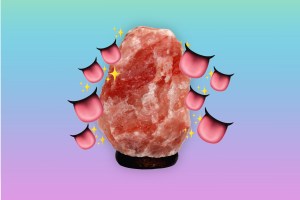 a photoshopped image of a himalayan salt lamp with emoji tongues and sparkles around it, in front of a blue and purple gradient background