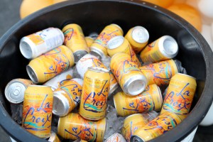 a bucket holding cans of tangerine and apricot la croix seltzer