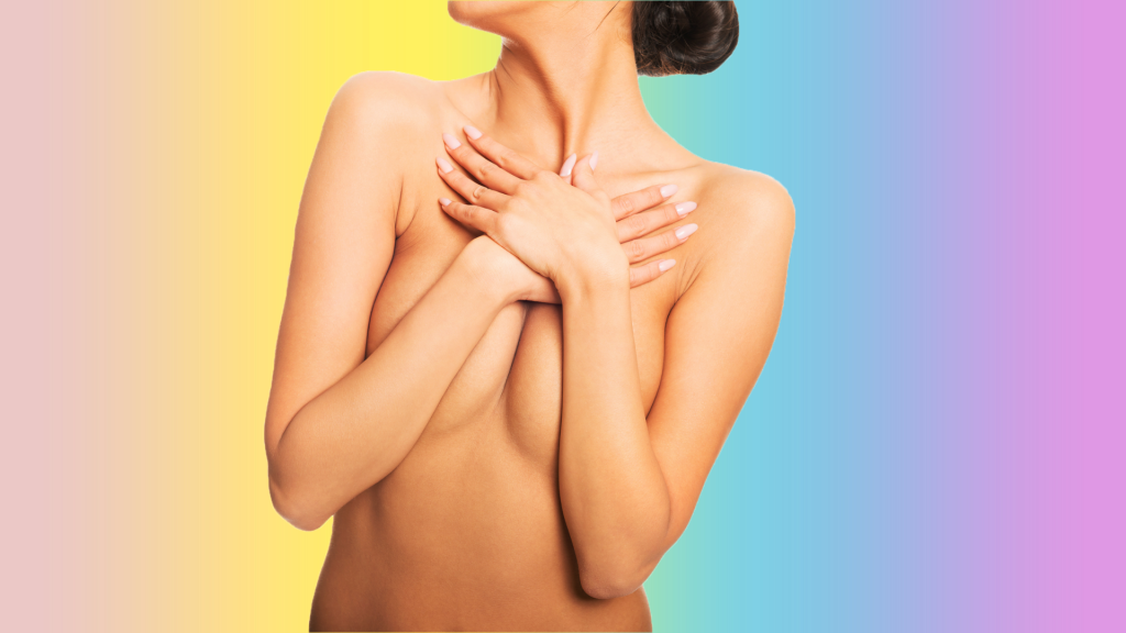 a woman holds her breasts with her hands