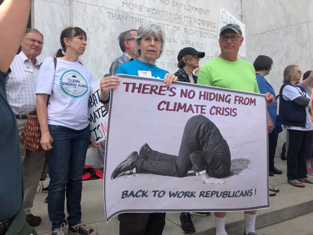 Protesters hold an anti-GOP sign