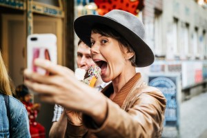 woman taking photo of ice cream selfie