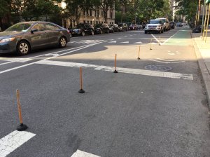 Toilet plunger bike lane barriers in New York City.