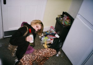 Girl celebrating in flat with alcohol