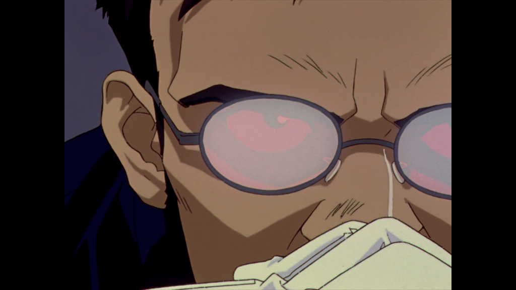 A screenshot from Neon Genesis Evangelion, a close up of Gendo Ikari's face with his hands steepled in front of his mouth. His glasses are glaring, just barely failing to fully block out his eyes.