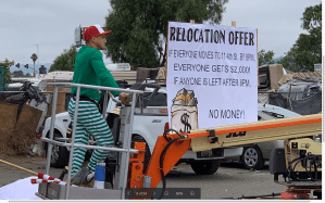 A Trump-loving real estate developer showed up to one of Oakland’s largest homeless encampments Friday morning.