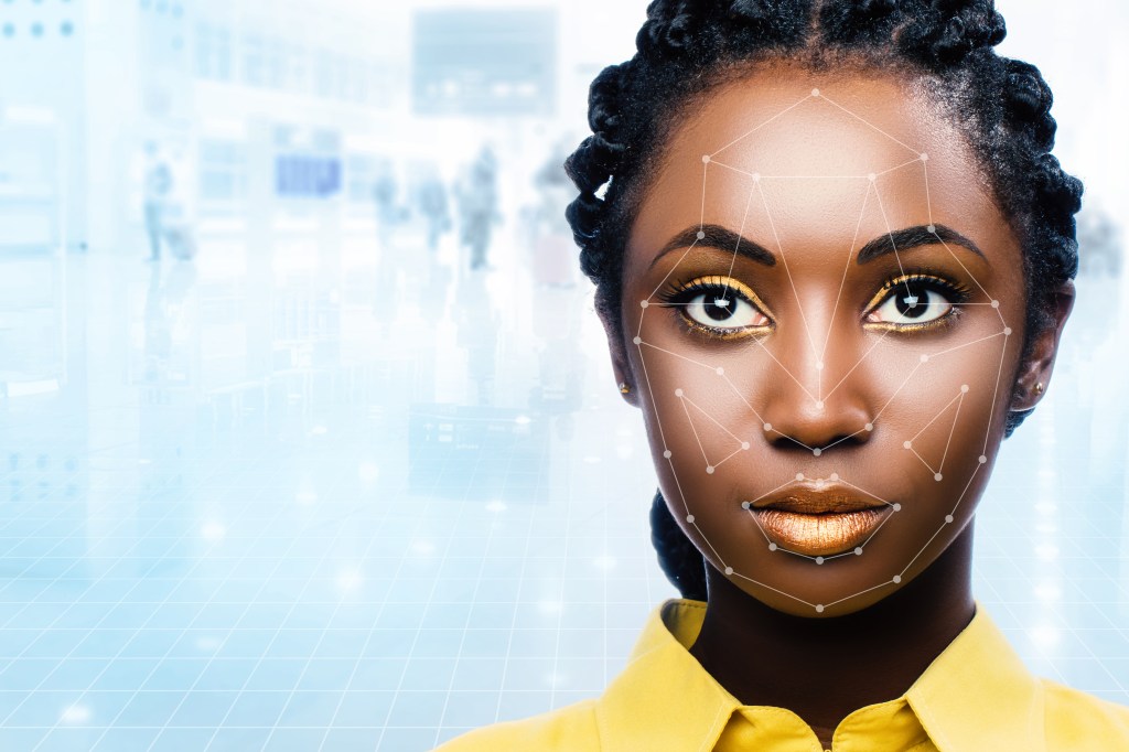 A Black woman being scanned by a facial recognition tool