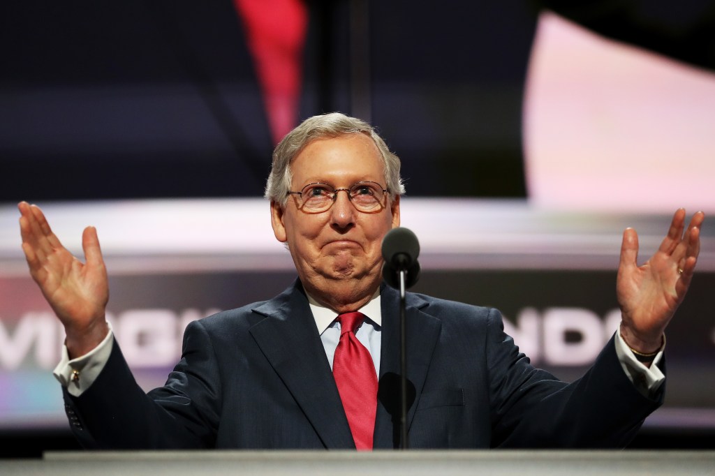 Mitch McConnell stands at a podium at the 2016 Republican National Convention.