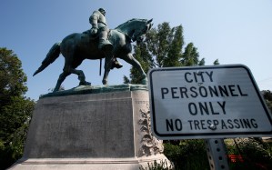 In this Monday, Aug. 6, 2018 photo, a No Trespassing sign is displayed in front of a statue of Robert E. Lee in Charlottesville, Va., at the park that was the focus of the Unite the Right rally.