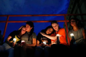 From left, Melody Stout, Hannah Payan, Aaliyah Alba, Sherie Gramlich and Laura Barrios comfort each other during a vigil for victims of the shooting Saturday, Aug. 3, 2019, in El Paso, Texas. A young gunman opened fire in an El Paso, Texas, shopping area