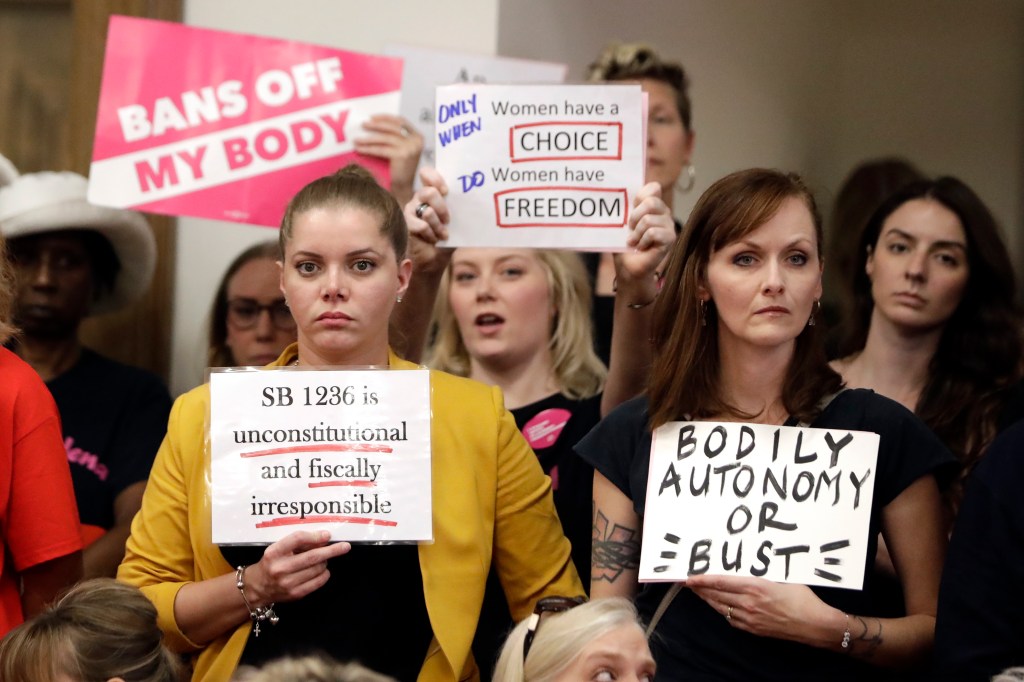 Protesters at a Senate hearing on a fetal heartbeat abortion ban, Aug. 12, 2019, in Nashville, Tenn. (AP Photo/Mark Humphrey)