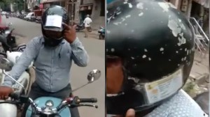 indian man sticks license on helmet to avoid fine