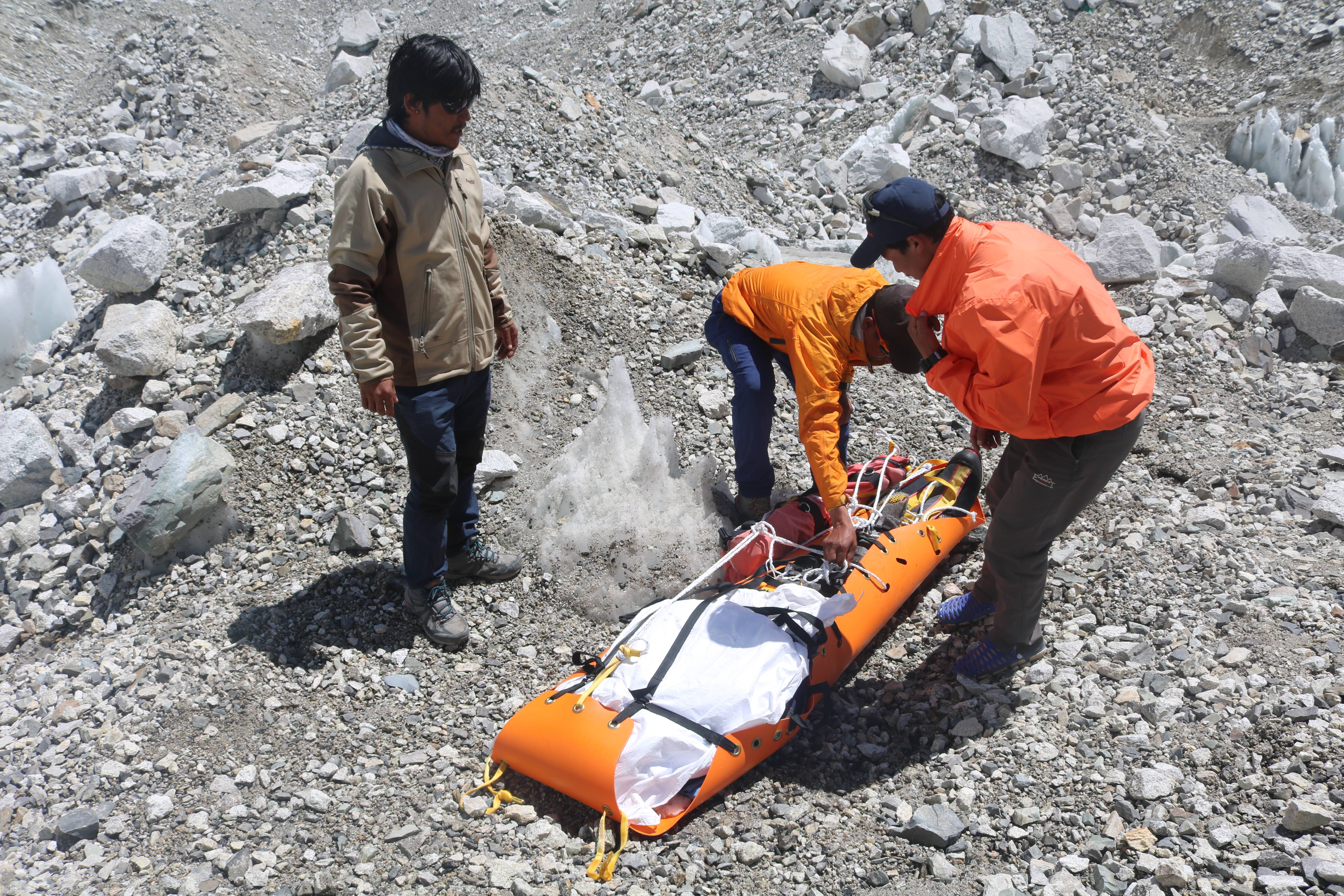 1568620875008-Rescue-personnel-wrapping-a-dead-body-found-on-Everest