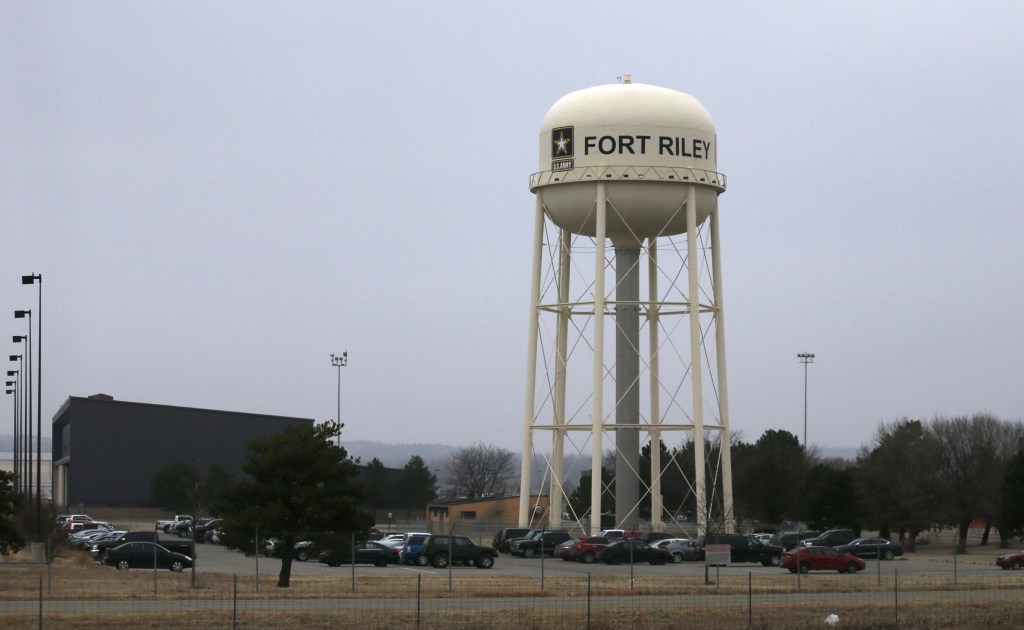 Cover: Vehicles park around a water tower at Fort Riley, Kan., Monday, Feb. 9, 2015. (AP Photo/Orlin Wagner)