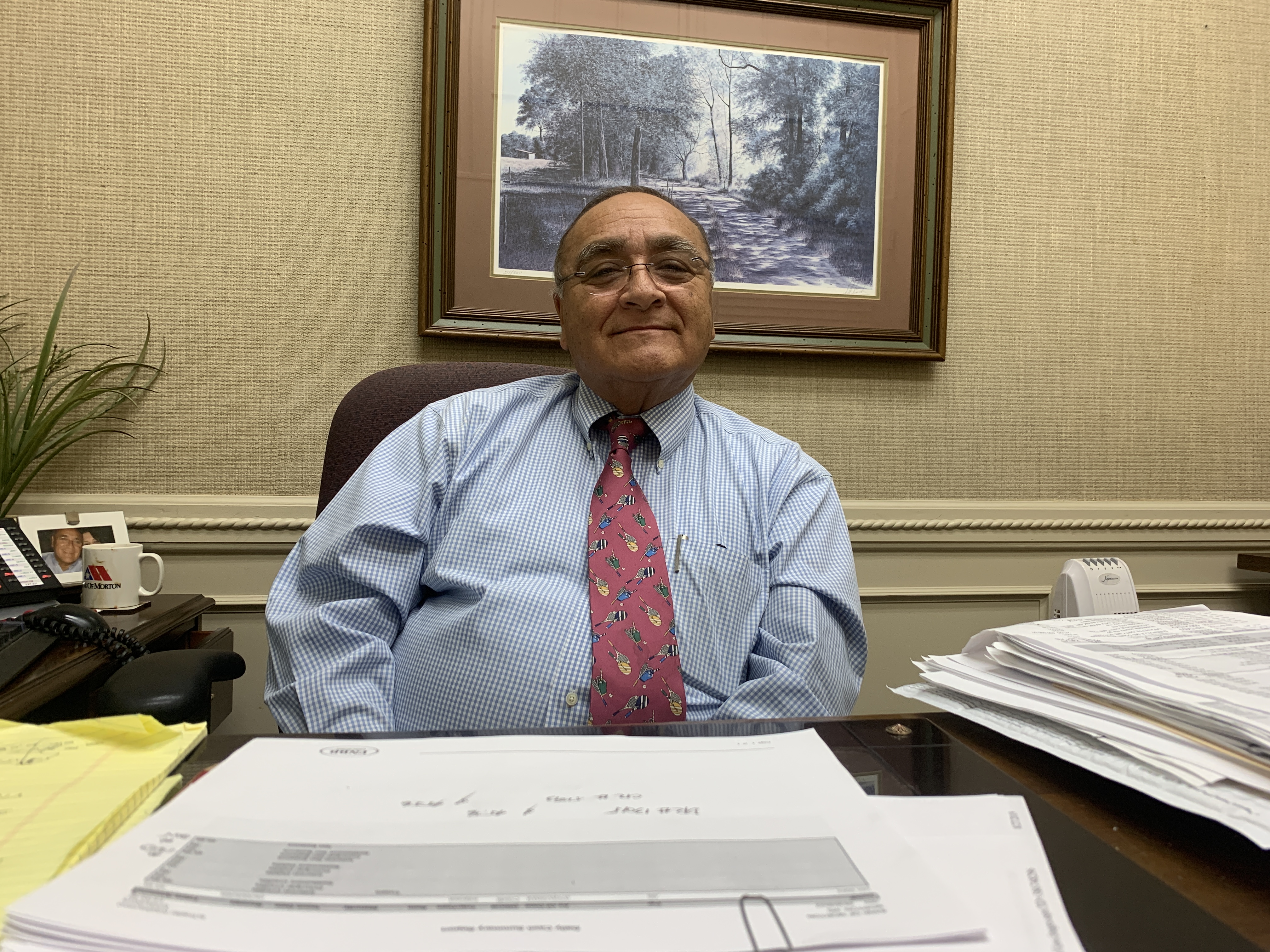 Tito Echiburu sits at a desk.