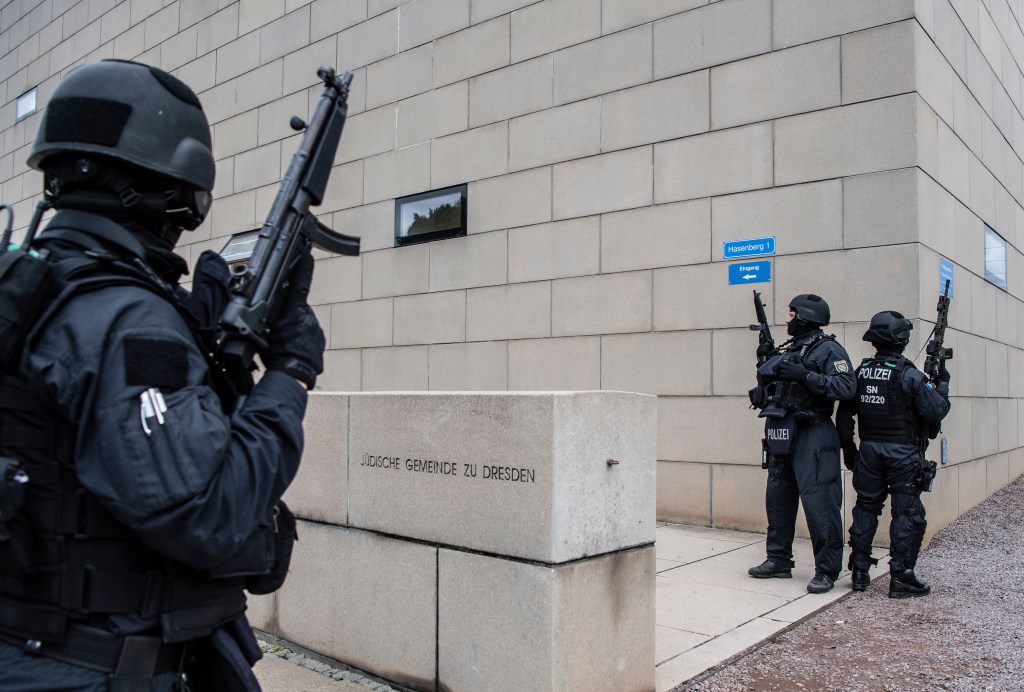 olice officers secure a synagogue in Dresden, Germany, Wednesday, Oct. 9, 2019. One or more gunmen fired several shots on Wednesday in the German city of Halle. Police say a person has been arrested after a shooting that left two people dead.