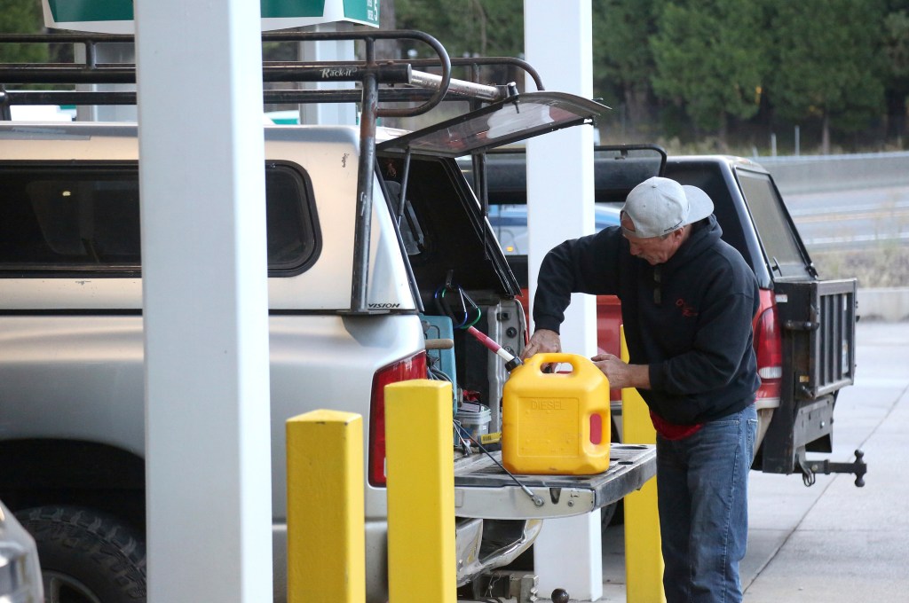 Gas customers fill up their extra gas cans at the Robinson Gas Station, Wednesday, Oct. 9, 2019 in Nevada City, Calif. Millions of people were poised to lose electricity throughout northern and central California after Pacific Gas & Electric Co. announced