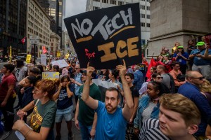 Activists holding a No Tech for ICE symbol