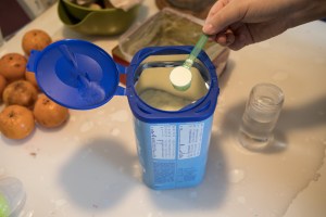 A woman prepares a bottle of instant formula in Beijing, China, on Saturday, Jan. 12, 2019. (Giulia Marchi/Bloomberg via Getty Images​)