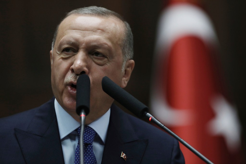 Cover: Turkish President Recep Tayyip Erdogan addresses his ruling party legislators at the Parliament, in Ankara, Wednesday, Oct 16, 2019. Erdogan called Wednesday on Syrian Kurdish fighters to leave a designated border area in northeast Syria 'as of ton