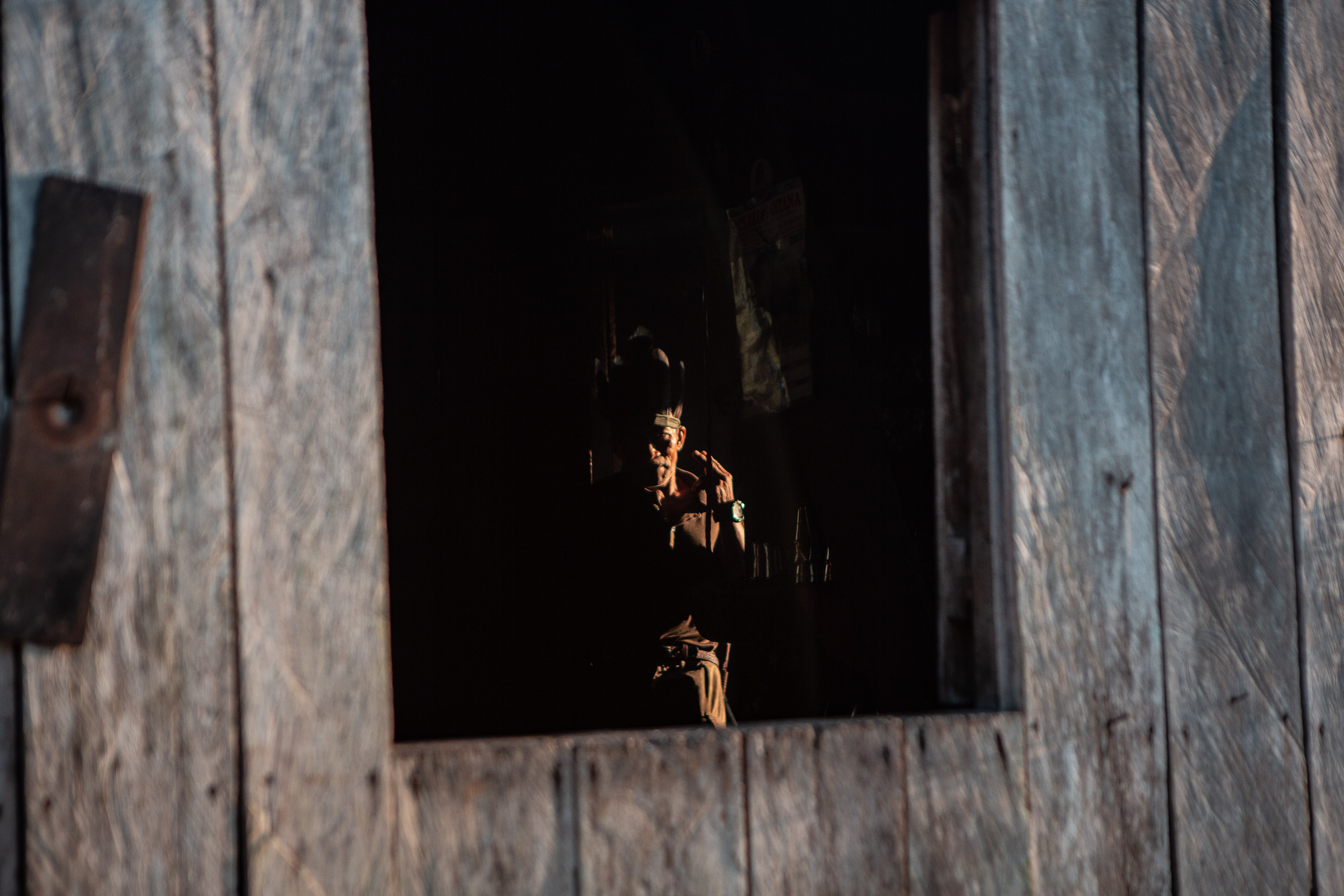 Indigenous man sitting at home in the dark