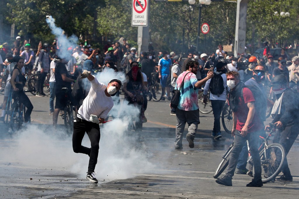 The charred remains of five people were discovered in a garment factory set fire by protesters on the outskirts of Chile’s capital Santiago Sunday, as weeks of simmering protests over inequality turned violent.