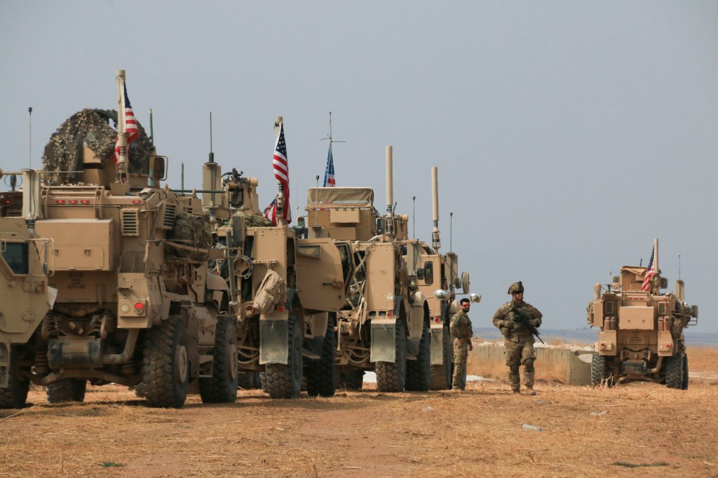 American military convoy stops near the town of Tel Tamr, north Syria, Sunday, Oct. 20, 2019. Kurdish-led fighters and Turkish-backed forces clashed sporadically Sunday in northeastern Syria amid efforts to work out a Kurdish evacuation from a besieged bo