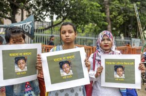 In this photo taken on April 12, 2019, Bangladeshi women hold placards and photographs of schoolgirl Nusrat Jahan Rafi at a protest in Dhaka, following her murder by being set on fire after she had reported a sexual assault. (