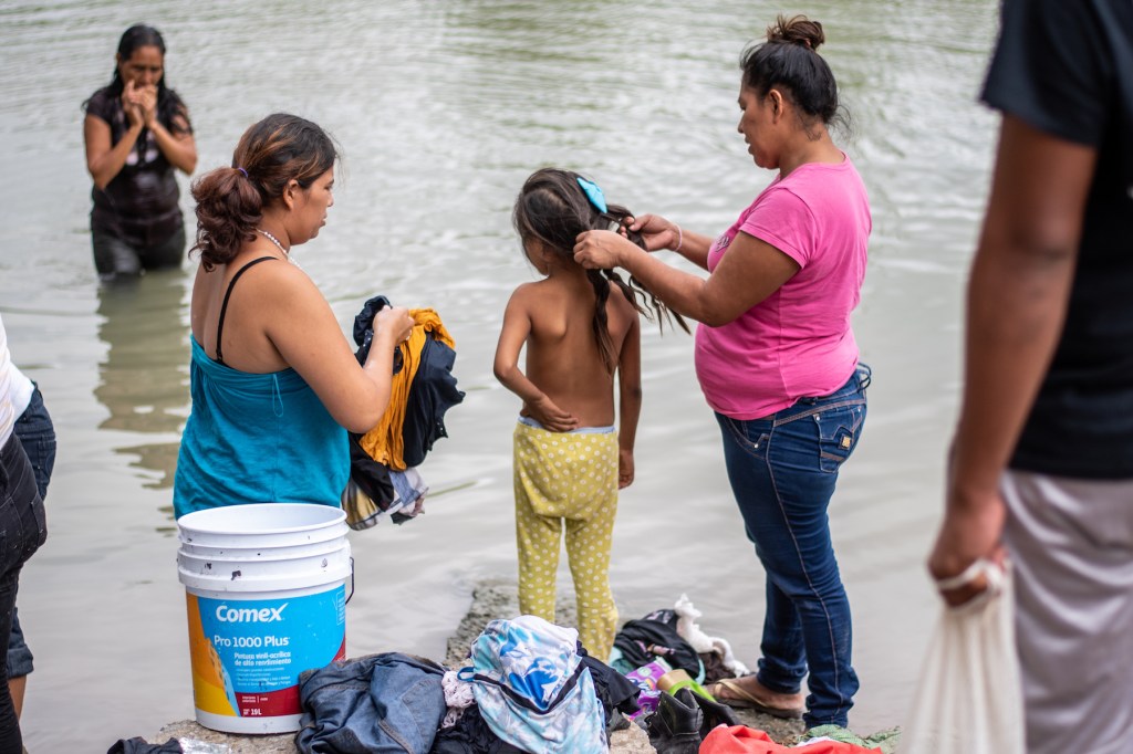 Women bathe and wash clothes in the Rio Grande. Photo by Sergio Flores.Bathingcamp