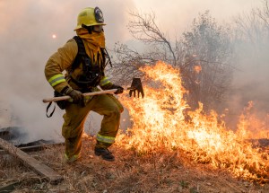 A firefighter from San Matteo helps fight the Kincade Fire in Sonoma County, Calif., on Sunday, Oct. 27, 2019. (AP Photo/Ethan Swope)​