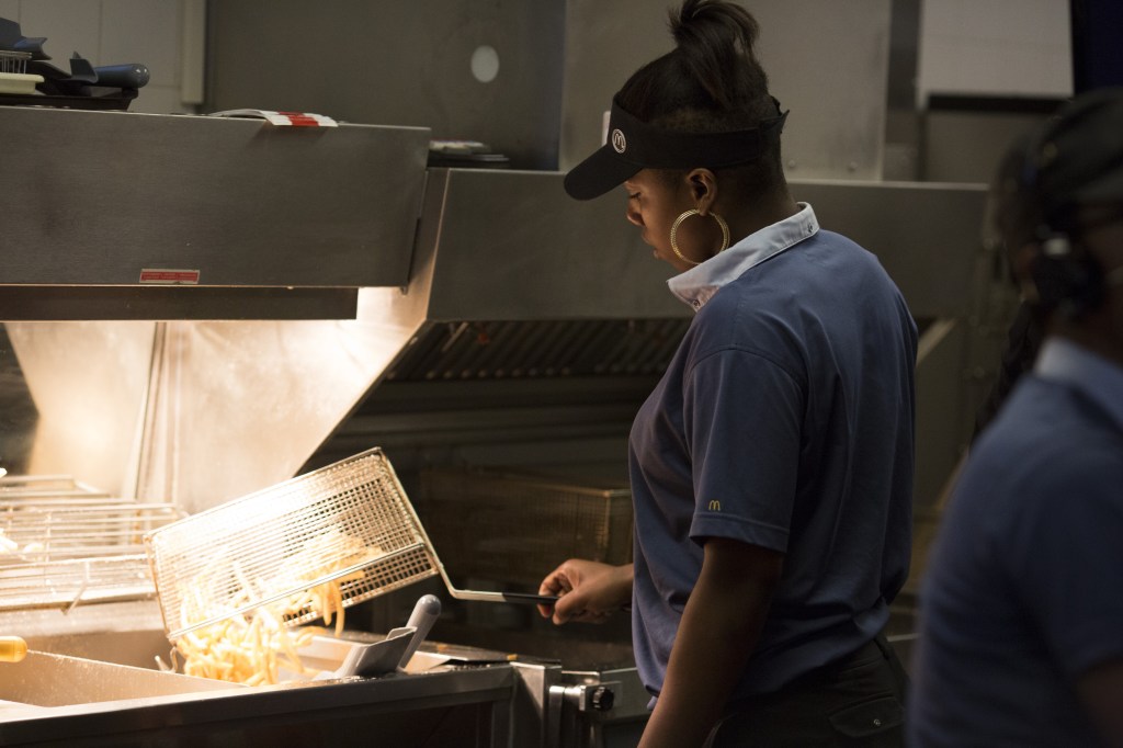 A McDonald's employee at a fry station.