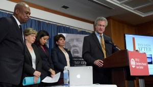 A man speaks at a lectern with the SPLC logo on it.