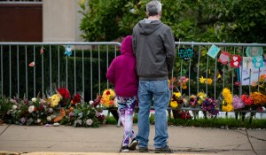 Visitors look at items well-wishers have left behind along the fence at the Tree of Life Synagogue on the 1st Anniversary of the attack on October 27, 2019 in Pittsburgh, Pennsylvania.